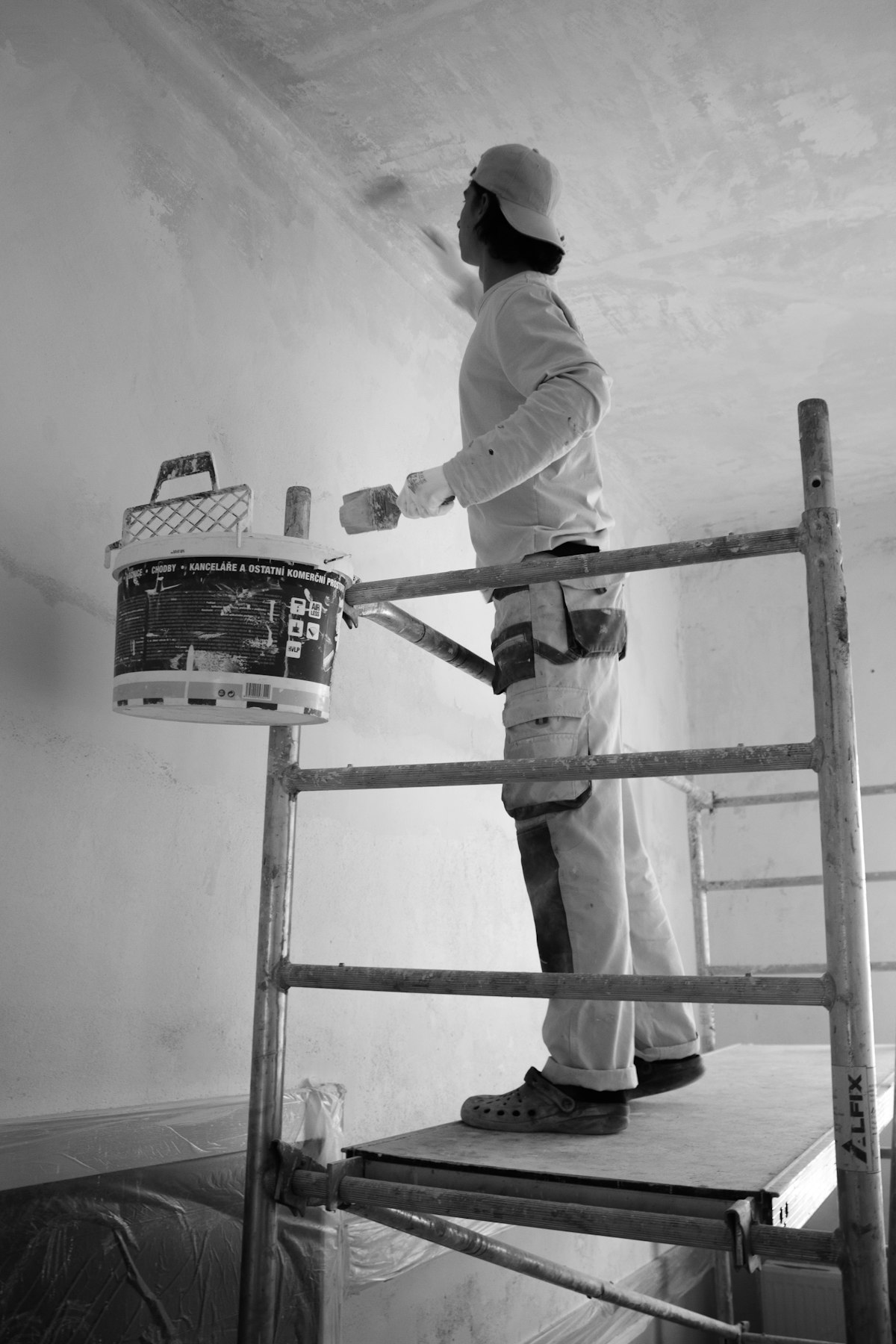 Painter applying a fresh coat with a roller